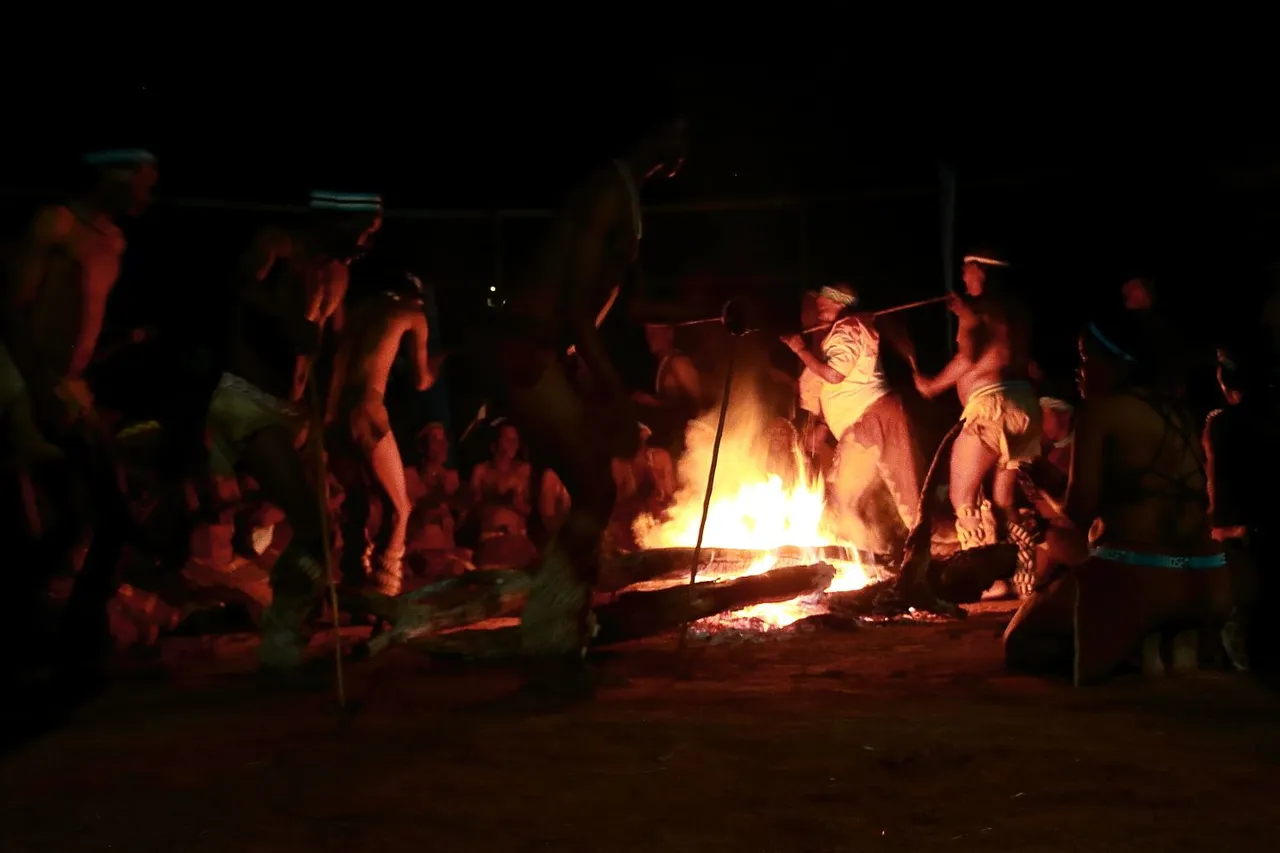 A campfire at a safari camp after sunset